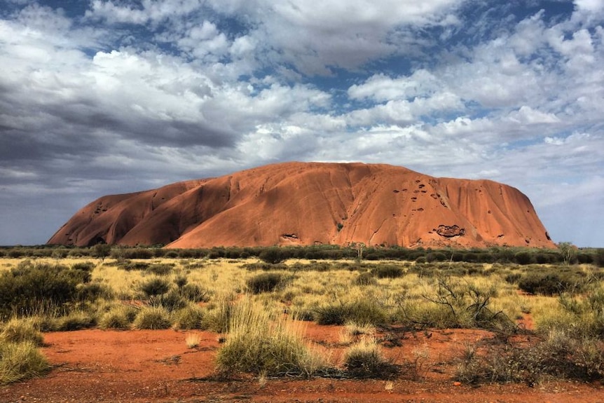 A photograph of Uluru during the day.