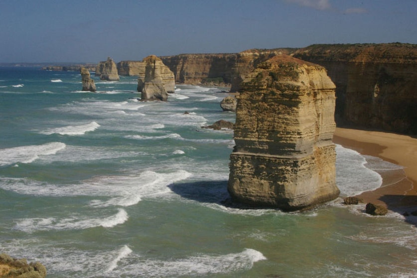 The Twelve Apostles, large chunks of rock sticking out of the blue ocean.