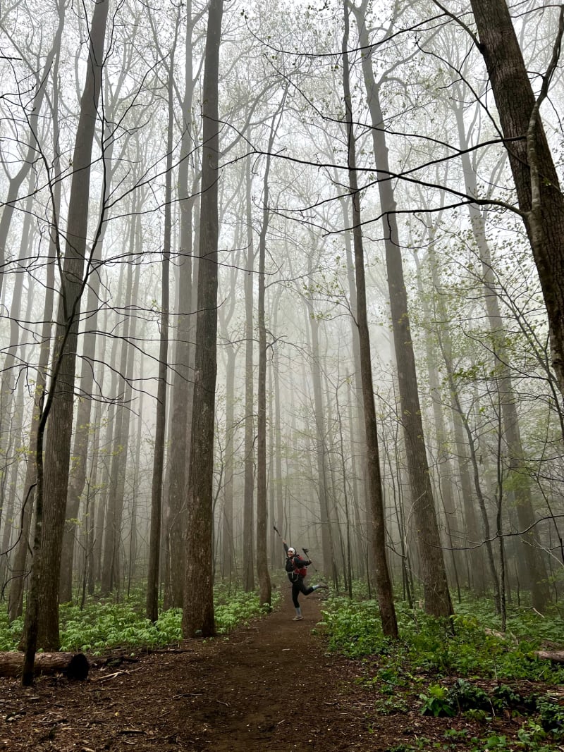 A woman posing in the trees while hiking outside of Atlanta.