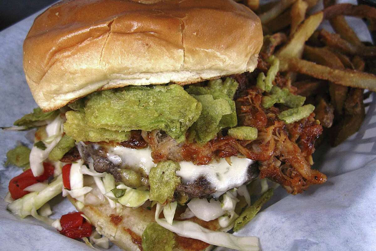 The Ultimate BBQ Burger includes a half pound beef patty, BBQ pulled pork, coleslaw, fried jalapeño chips and a side of fries at Luther's Cafe.