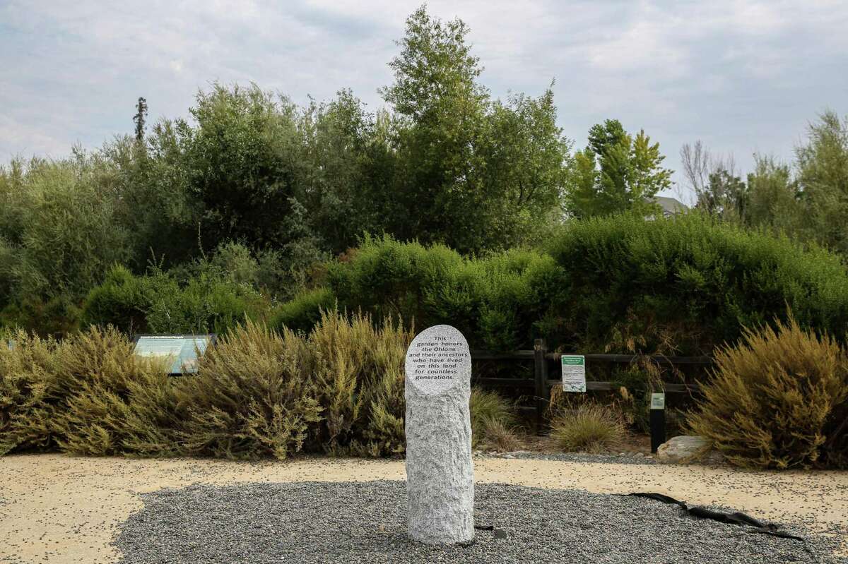 A stone sign dedicated to the Ohlone Tribes, the original inhabitants of the Bay Area, can be seen at Upper Penitencia Creek Contemplative Garden on the Bay Area Ridge Trail in San Jose, Calif., Monday, July 26, 2021. The trail is 550- miles of proposed road that would bypass the nine county area.  It is approaching 400 miles of track completed after 30 years of work.